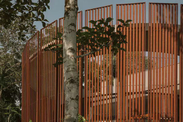 Timber-screened wellness pavilion among tropical trees