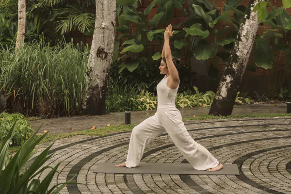 Guest practising yoga in the garden courtyard